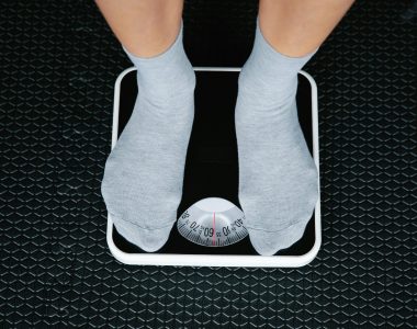 Person Standing On Scale To Measure Weight Loss