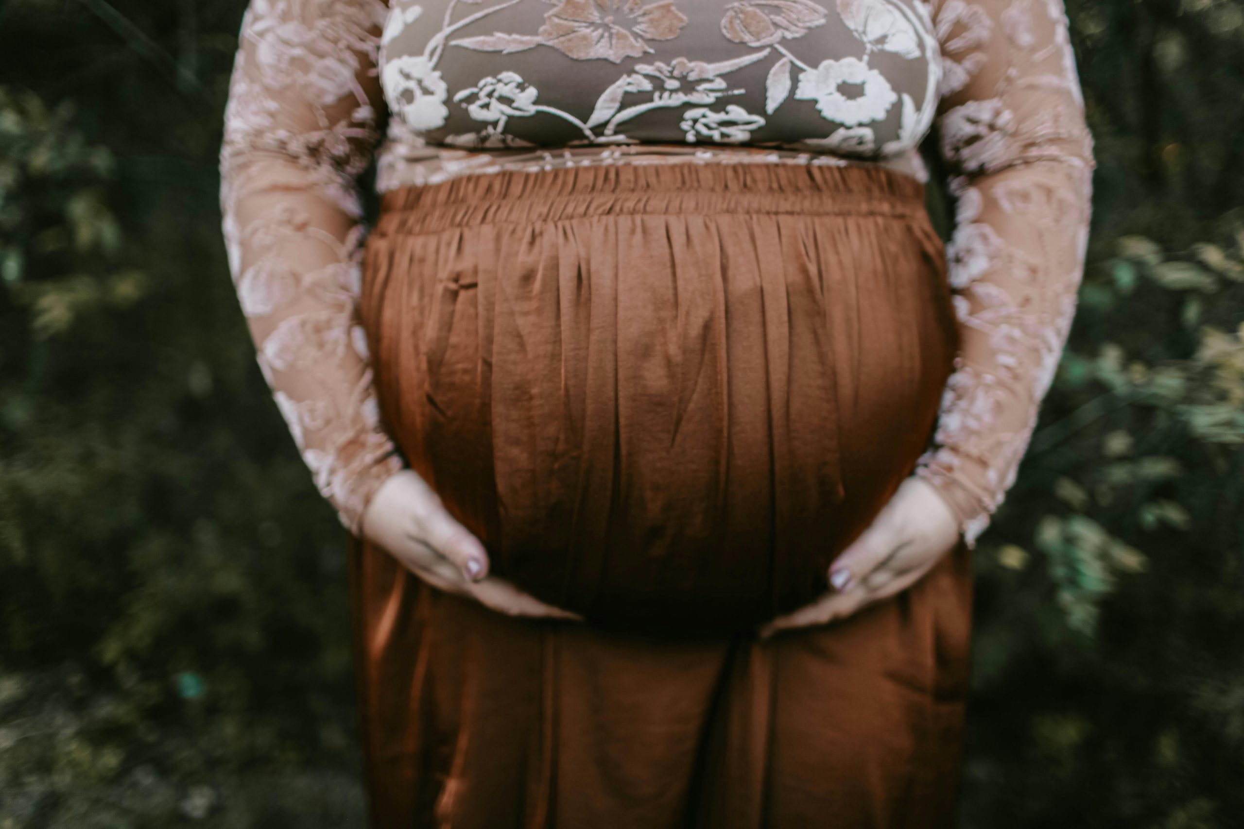 Pregnant woman holding belly
