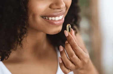 Beauty Supplement Closeup Of Smiling Black Woman Taking Vitamin Pill Picture Id1227501239