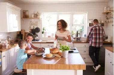Family At Home Eating Breakfast In Kitchen Together Picture Id613765314 Copy