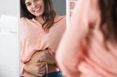 Happy Woman Measuring Waist With A Tape Picture Id924559740