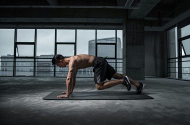 Man Working Out In An Empty Room On A Mat
