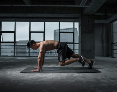 Man Working Out In An Empty Room On A Mat