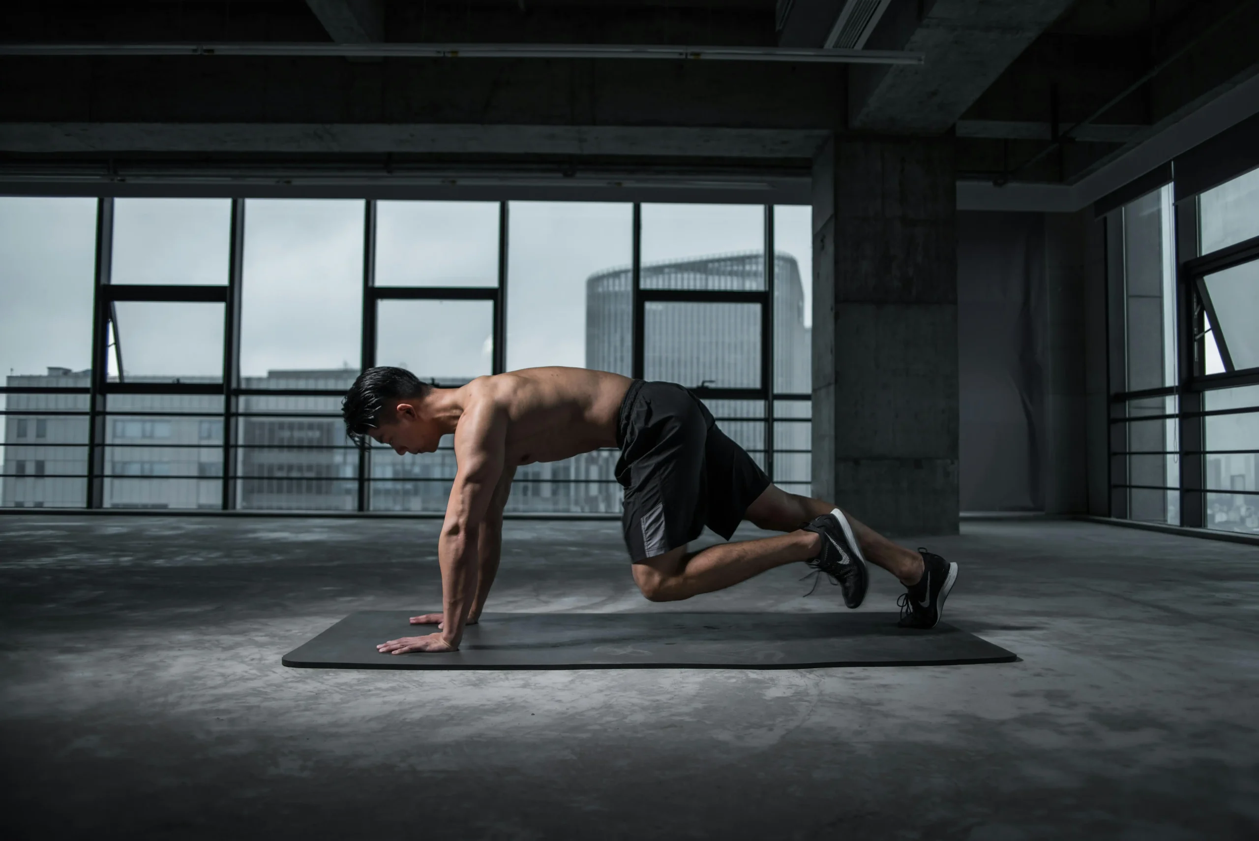 man working out in an empty room on a mat