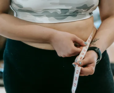 Person Measuring Their Waistline For Weight Loss