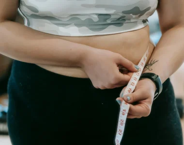 Person Measuring Their Waistline For Weight Loss