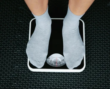 Person Standing On Scale To Measure Weight Loss