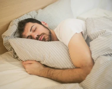 Man Sleeping In A Bed