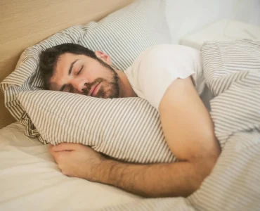 Person Sleeping In A Bed