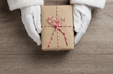 Santa Claus Hands Is Holding A Brown Gift Box Picture Id1177864040