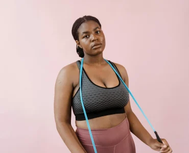 Woman In Gym Attire Holding A Jump Rope