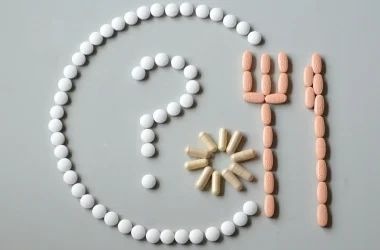 A Plate And Cutlery Made Out Of Pills With A Question Mark Inside