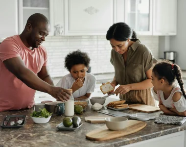 Family Cooking A Meal Together In A Kitchen