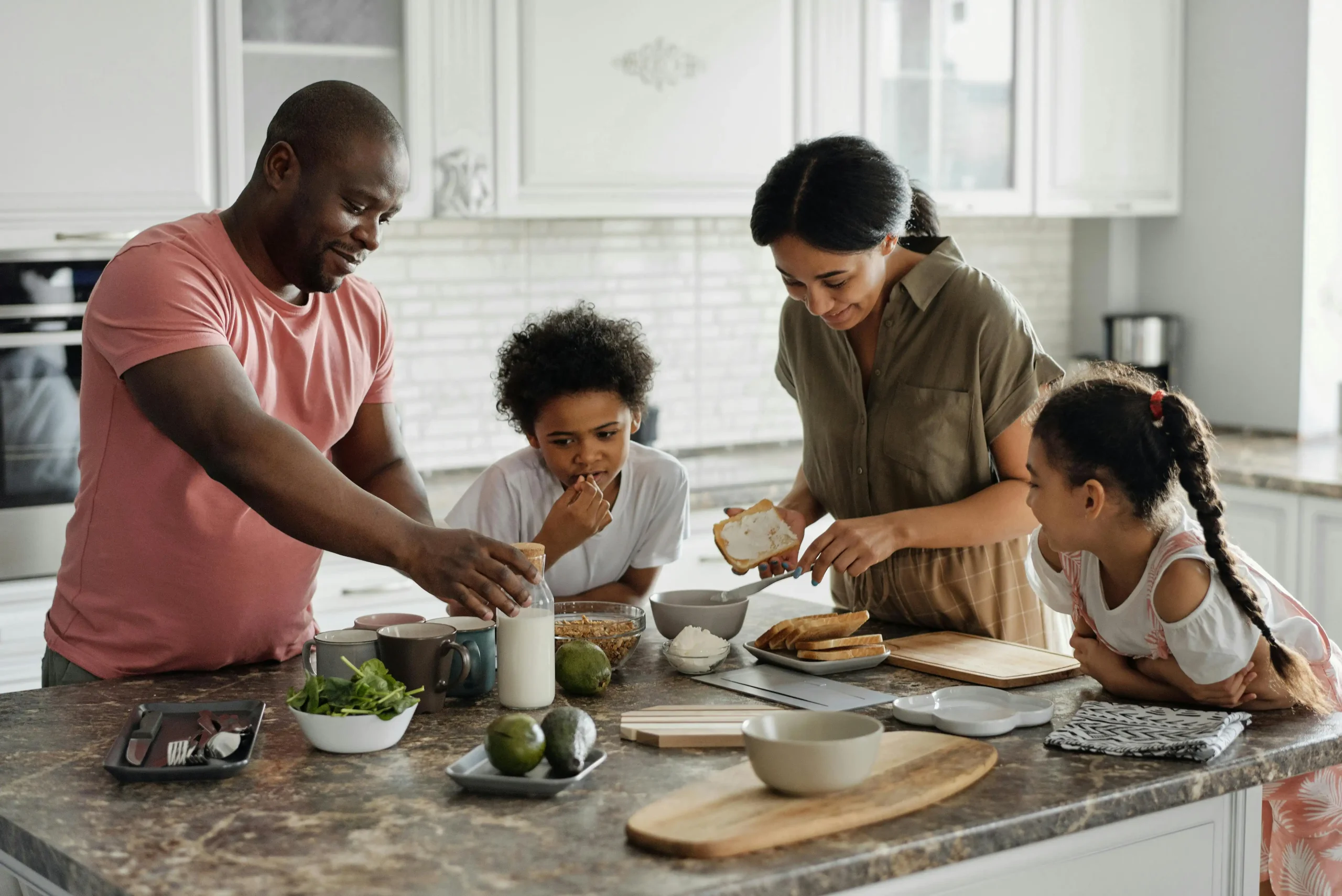 Family cooking a meal together in a kitchen