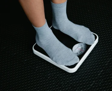 Person Standing On A Scale To Measure Weight Loss