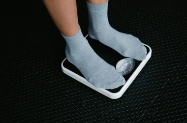 Person Standing On A Scale To Measure Weight Loss