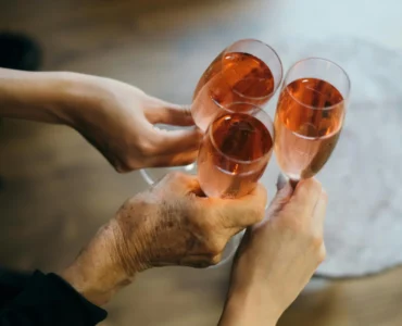 Three People Cheersing Glasses