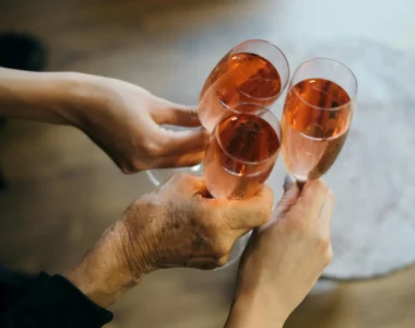 Three People Cheersing Glasses