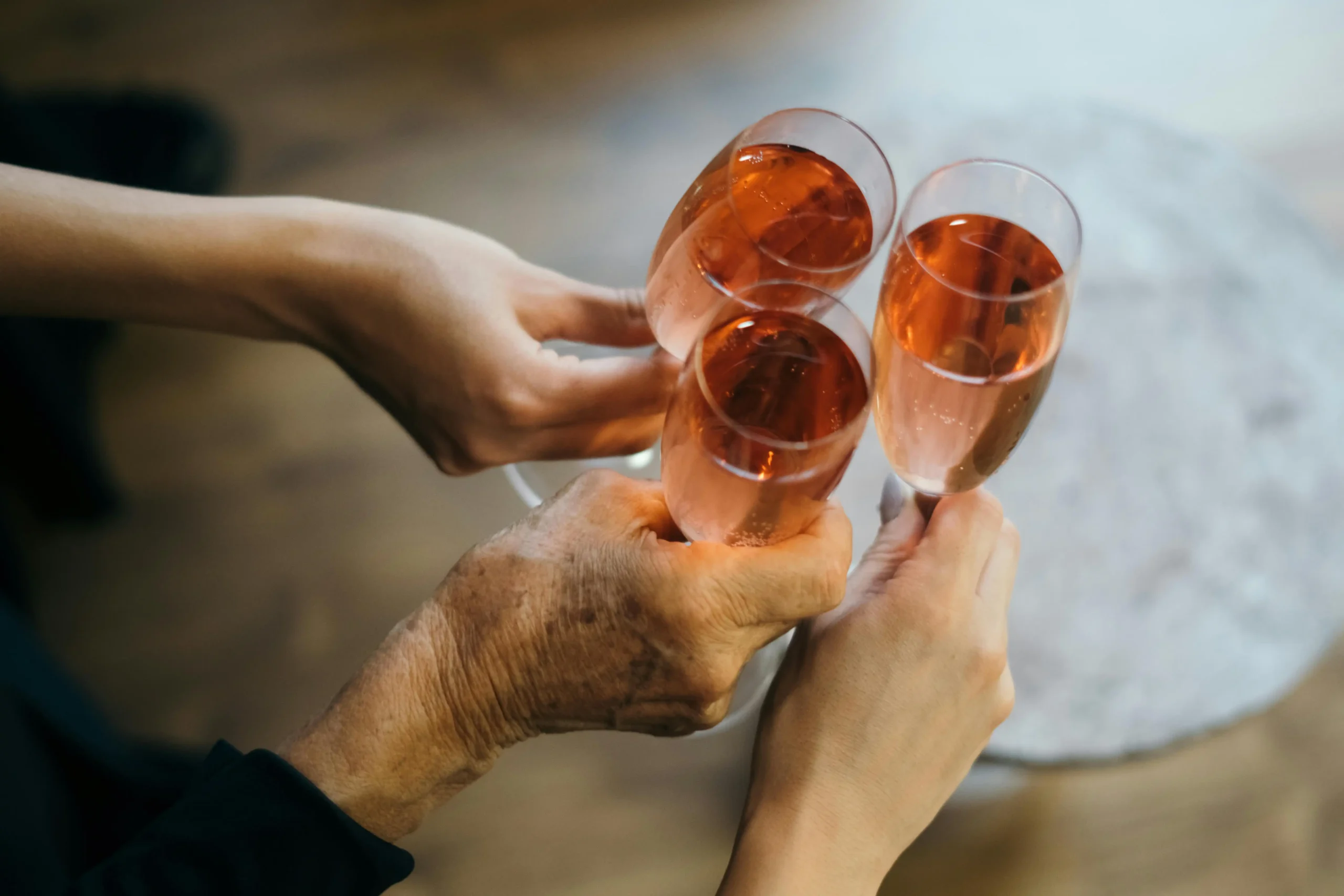 Three people cheersing glasses